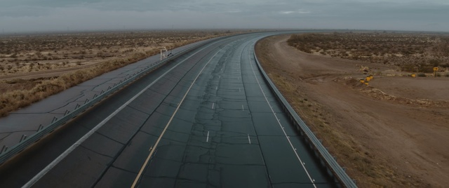 Video Reference: road, highway, infrastructure, horizon, lane, road surface, controlled access highway, sky, fixed link, line, Person