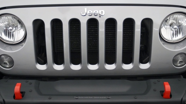 Video Reference: motor vehicle, grille, automotive lighting, bumper, automotive exterior, vehicle, headlamp, light, jeep, automotive tire, Person