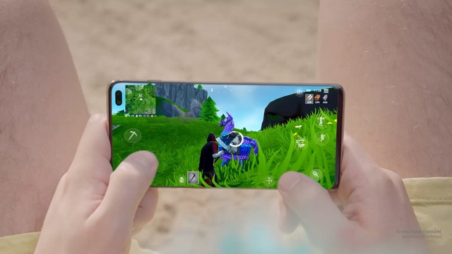 Video Reference: Gadget, Green, Electronic device, Technology, Game controller, Input device, Fictional character, Person, Holding, Hand, Cellphone, Phone, Table, Man, Using, Sitting, Woman, Young, Food, Screenshot, Cartoon, Electronics