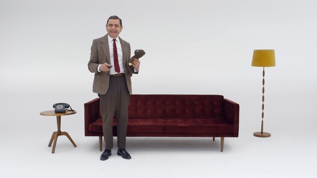 Video Reference: Furniture, Standing, Suit, Sitting, Table, Formal wear, Businessperson, Public speaking, White-collar worker, Job