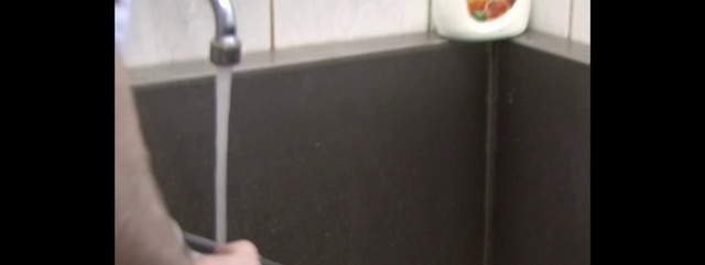 Video Reference: Tile, Plumbing fixture, Shower, Bathroom, Room, Plumbing, Flooring, Indoor, Mirror, White, Door, Sitting, Black, Front, Standing, Sink, Man, Holding, Reflection, Tiled, Young, Woman, Restroom, Green, Teeth, Food, Cat, Brushing, Kitchen, Wall