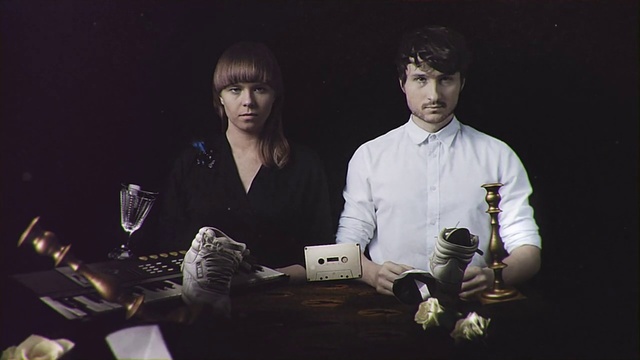 Video Reference: Photography, Adaptation, Black-and-white, Games, Art, Person, Table, Indoor, Man, Woman, Sitting, Front, Holding, Couple, Posing, Standing, Computer, People, Laptop, Desk, Young, Cake, White, Group, Human face, Clothing, Text