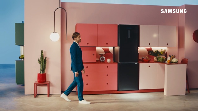 Video Reference: Room, Furniture, Interior design, House, Cabinetry, Indoor, Red, Building, Small, Table, Standing, Toy, Front, Sitting, Black, Woman, Holding, Living, Orange, Man, Desk, Bedroom, Playing, Young, Large, Suitcase, Computer, Kitchen, White, Luggage, Floor, Wall, Footwear, Clothing, Person