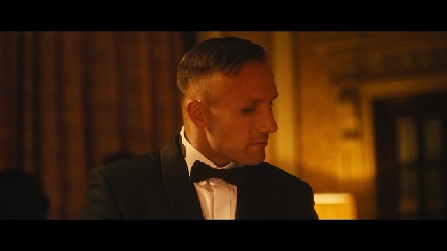 Video Reference: Suit, Gentleman, Forehead, Formal wear, Screenshot, Tuxedo, Portrait, White-collar worker