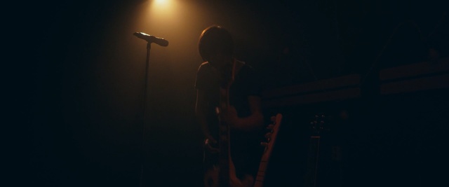 Video Reference: darkness, performance, rock concert, concert, entertainment, microphone, singing, light, string instrument, event