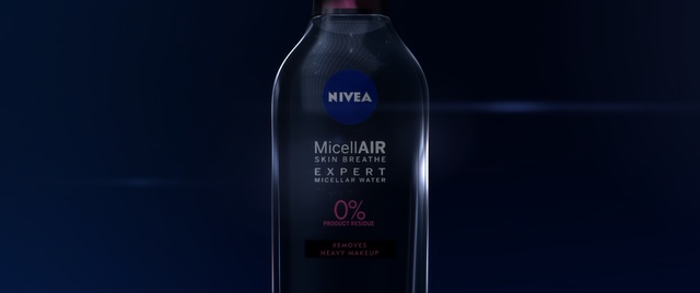 Video Reference: Product, Water, Liquid, Fluid, Bottle, Material property, Hair care, Drink, Plastic bottle, Personal care, Indoor, Thing, Sitting, Table, Glass, Food, Black, Lotion, Computer, Wine, Holding, White, Alcohol, Text, Soft drink, Beer, Solution, Beverage, Solvent, Water bottle