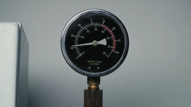 Video Reference: Gauge, Measuring instrument, Tool, Auto part, Tachometer, Thing, Clock, Device, Indoor, Black, Sitting, Metal, Hanging, Large, Post, Pole, Standing, White, Water, Wall, Watch, Wall clock