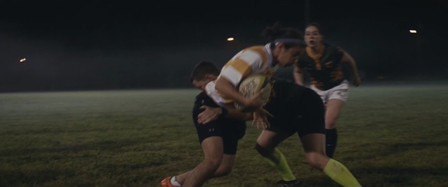 Video Reference: Rugby union, Rugby, Rugby league, Rugby player, Rugby sevens, Team sport, Tackle, Touch rugby, Ball game, Player, Grass, Person, Outdoor, Game, Sport, Playing, Field, Man, Ball, Running, Frisbee, Soccer, Young, Green, Night, Woman, Group, People, Catch, White, Standing, Athletic game, Sports equipment, Football
