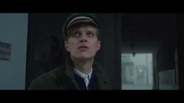 Video Reference: Face, Head, Screenshot, Human, Gentleman, Movie, Darkness, Fun, Facial hair, Scene, Person, Man, Photo, Standing, Front, Looking, Wearing, Holding, Young, Woman, Suit, Dark, Posing, Shirt, Room, White, Sign, Human face, Video game, Text, Clothing, Portrait