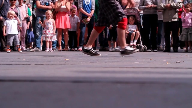 Video Reference: footwear, road, infrastructure, crowd, street, shoe, pedestrian, recreation, performance art, event