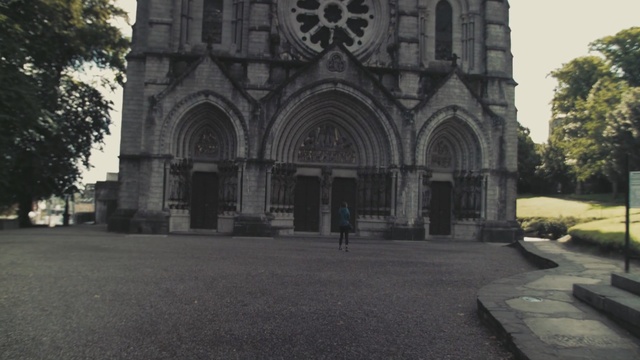 Video Reference: building, medieval architecture, arch, place of worship, church, facade, cathedral, tree, abbey, sky, Person