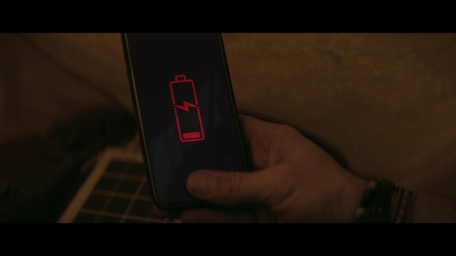 Video Reference: Black, Red, Light, Text, Finger, Electronics, Hand, Design, Material property, Font, Indoor, Person, Computer, Sitting, Laptop, Table, Keyboard, Front, Using, Remote, Dark, Holding, Man, Apple, Screen, Young, Mouse, White, Laying, Bed, Screenshot, Mobile phone