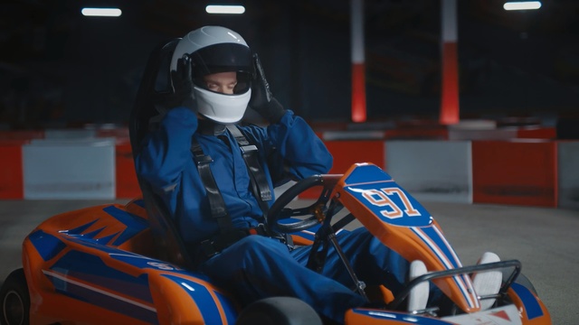 Video Reference: Helmet, Personal protective equipment, Vehicle, Kart racing, Go-kart, Automotive design, Headgear, Motorsport, Racing, Motorcycle helmet, Person