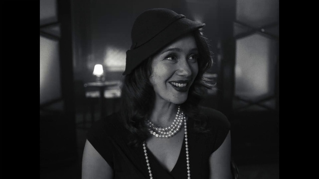 Video Reference: Hair, Face, Smile, Lip, Eyebrow, Flash photography, Hat, Standing, Black-and-white, Style
