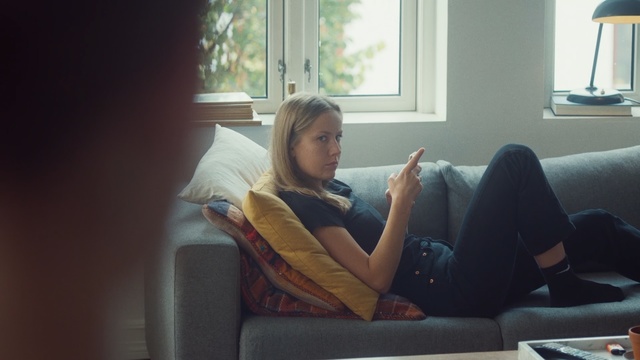 Video Reference: Couch, Room, Furniture, Leg, Sitting, Comfort, Sunlight, Blond, Vacation, Living room, Person