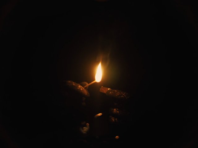 Video Reference: match, flame, fire, darkness, close-up, hands, gloves, lighting, night, low-light, spark, ignition, candlelight, minimal, moody, dark