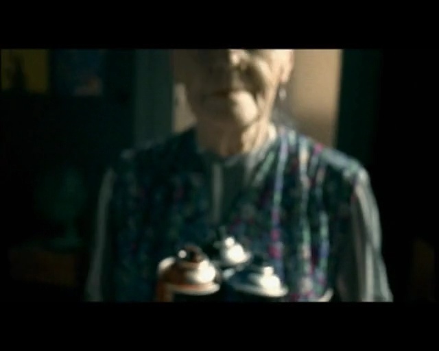 Video Reference: Music, Darkness, Portrait, Human, Fun, Photography, Cool, Mouth, Hand, Smile, Person, Man, Table, Looking, Front, Wearing, Holding, Room, Standing, Dark, Black, Young, Woman, Shirt, Suit, White, Cake, Hat, Phone, Red, Screenshot, Human face, Clothing