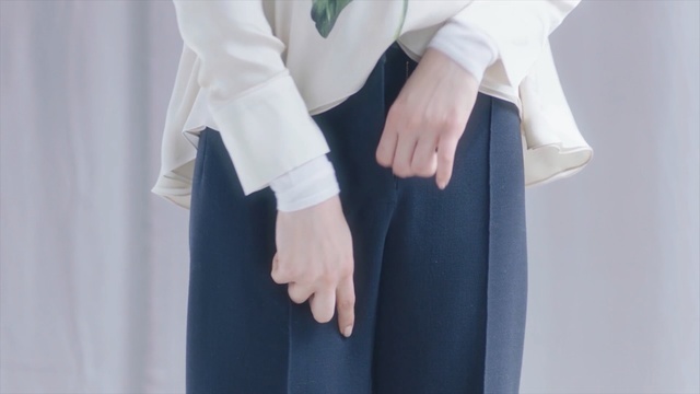 Video Reference: White, Product, Formal wear, Hand, Uniform, Gesture, Outerwear, Dress, Trousers, Sleeve
