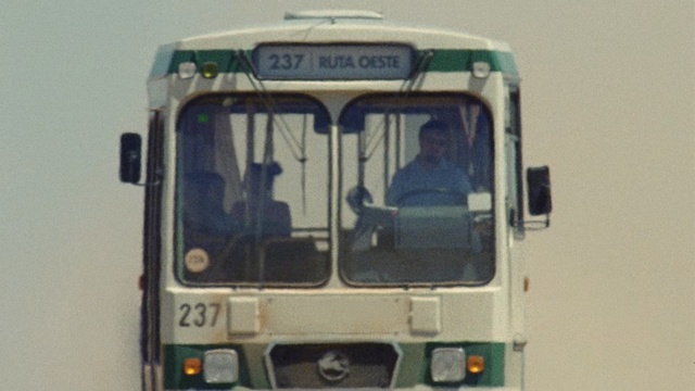 Video Reference: Land vehicle, Transport, Mode of transport, Vehicle, Motor vehicle, Commercial vehicle, Bus, Car, Public transport, Paz-3205, Outdoor, Road, Driving, Truck, White, Train, Photo, Traveling, Passenger, Street, Black, Mirror, Parked, Snow, Man, Door, Riding, People, City, Track, Double, Text, Van