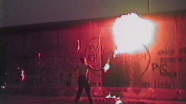 Video Reference: Red, Photograph, Performance art, Stage, Performance, Art, Pink, Snapshot, Light, Wall, Fire, Hydrant, Stop, Man, Blurry, Painted, Dark, Sunset, Walking, Street, Yellow, Graffiti, Sign, Covered, Night, Standing, City, Riding, Text, Painting, Drawing