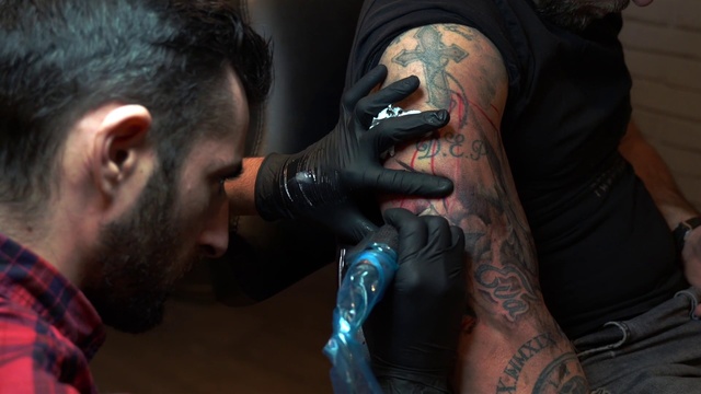Video Reference: Tattoo, Skin, Arm, Neck, Human, Flesh, Tattoo artist, Ear