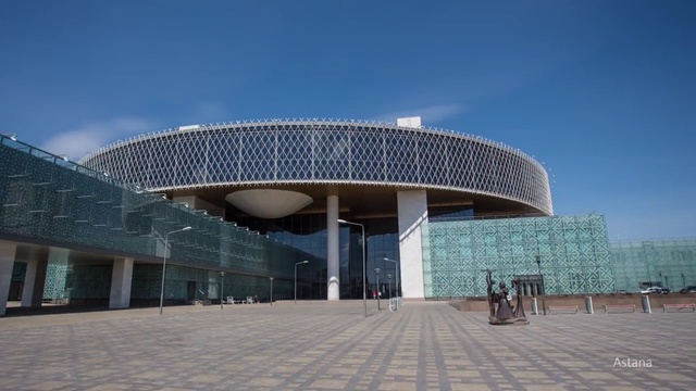 Video Reference: landmark, sky, building, architecture, structure, daytime, corporate headquarters, metropolitan area, convention center, facade, Person