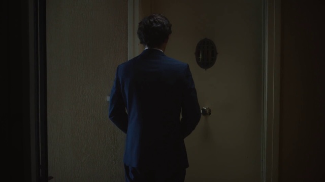 Video Reference: Black, Standing, Suit, Formal wear, Outerwear, Room, Photography, Blazer, Darkness, Door