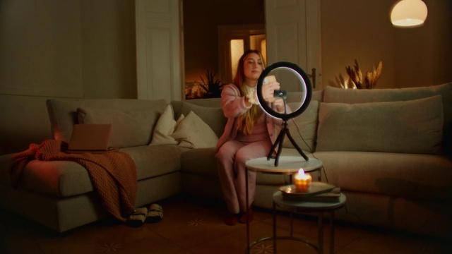 Video Reference: Hairstyle, Furniture, Smile, Property, Couch, Comfort, Leg, Table, Picture frame, Dress