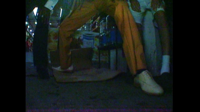 Video Reference: Art, Snapshot, Darkness, Photography, Leg, Hand, Room, Visual arts, Person, Man, Sitting, Front, Young, Holding, Light, Standing, Boy, Woman, Television, Bus, Board, Red, Street, Bed, Phone, Doing, Luggage, Furniture