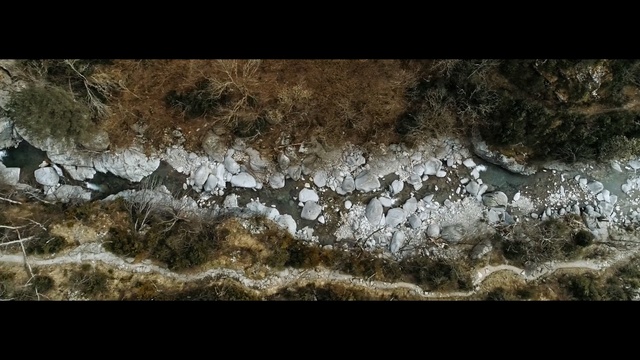 Video Reference: Nature, Brown, Rock, Geology, Formation, Water, Wall, Organism, Soil, Font, Sitting, Snow, Standing, Sheep, Field, Man