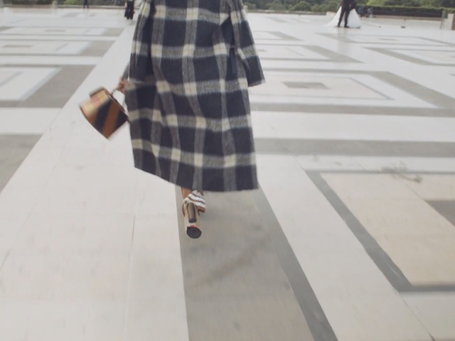 Video Reference: outerwear, design, line, pattern, floor, plaid, Person