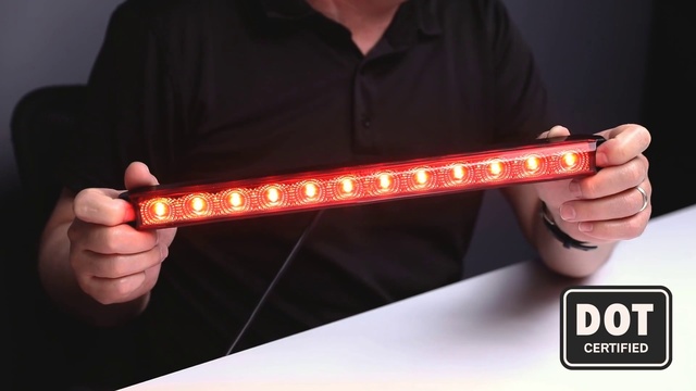 Video Reference: Light, Lighting, Amber, Emergency light, Font, Neon, Visual effect lighting, Person, Holding, Red, Remote, Man, Hand, Black, Shirt, Food, Wearing, Front, Video, Screen, Control, Wii, Young, Television, Game, Sign, Bat, Player, Blue, Text