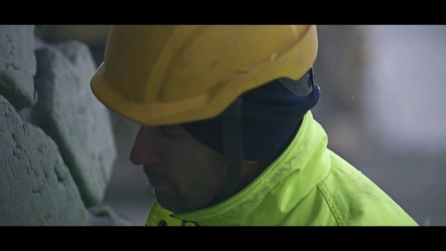 Video Reference: yellow, personal protective equipment, screenshot, headgear, hazmat suit, hard hat, Person