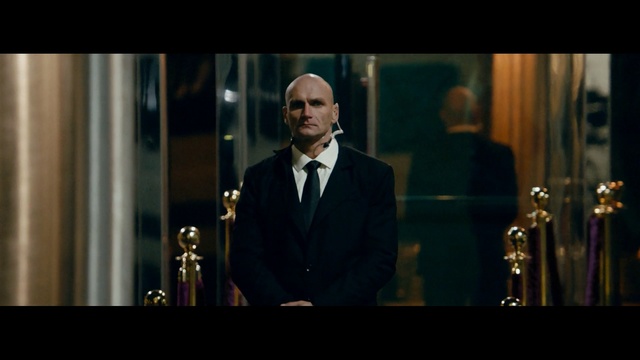 Video Reference: gentleman, speech, suit, official, screenshot, formal wear, darkness, night, midnight, Person
