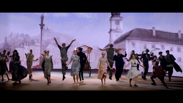 Video Reference: Photograph, Fun, Event, Photography, Dance, Performance art, Ceremony, Performance, Crowd, Tourism, Person, Outdoor, Road, Group, Walking, People, Man, Front, Street, Standing, Old, Cross, Large, Holding, Beach, Game, Riding, City, Runway, Clothing, Dress, Woman