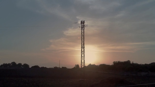 Video Reference: Sky, Tower, Atmospheric phenomenon, Cloud, Evening, Transmission tower, Sunset, Horizon, Tree, Electricity