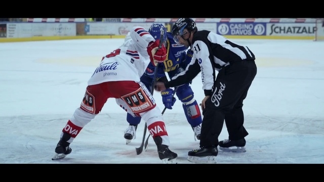 Video Reference: College ice hockey, Ice hockey, Ice hockey position, Sports, Sports gear, Hockey protective equipment, Team sport, Hockey, Player, Bandy, Person, Building, Snow, Outdoor, Skiing, Racing, Man, Slope, Riding, Covered, Hill, Water, People, Standing, White, Baseball, Field, Group, Rink, Ice skating, Sports equipment, Clothing