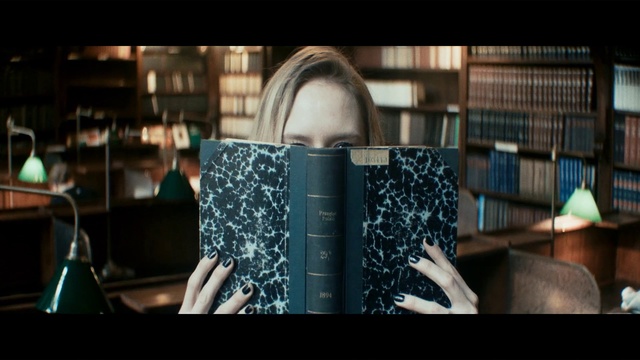 Video Reference: Photograph, Product, Snapshot, Fashion, Font, Photography, Design, Audio equipment, Textile, Dress, Person, Indoor, Table, Woman, Front, Sitting, Looking, Young, Room, Living, Man, Holding, Library, Girl, White, Black, Computer, Standing, Phone, Book, Text, Human face, Laptop