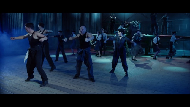 Video Reference: Choreography, Performing arts, Dance, Performance, Event, Dancer, Performance art, Musical theatre, Sports, Person, Walking, Holding, Man, Standing, People, Woman, Court, Group, Street, Sidewalk, Playing, City, Young, Suit, Large, Soccer, Ball, Room, White, Floor, Clothing, Screenshot