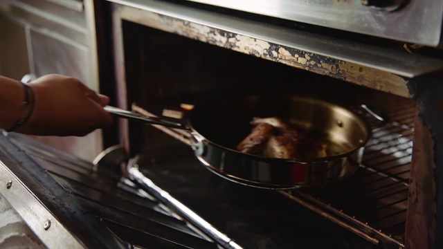 Video Reference: Cooking, Cookware and bakeware, Food, Dish, Cuisine, Recipe, Stove, Roasting, Indoor, Cabinet, Person, Oven, Kitchen, Pan, Woman, Preparing, Cooked, Pot, Pulling, Sitting, Wooden, Using, Man, Steel, Young, Pizza, Wok, Frying pan, Home appliance, Outdoor grill rack & topper, Barbecue grill, Putting, Outdoor grill, Kitchen appliance