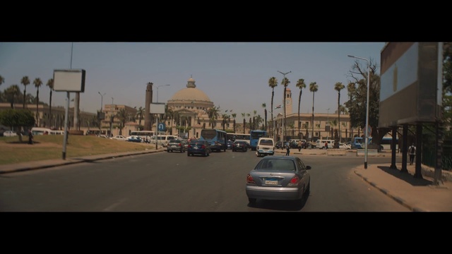 Video Reference: Sky, Urban area, Road, Mode of transport, Town, Street, Landmark, Atmospheric phenomenon, City, Morning