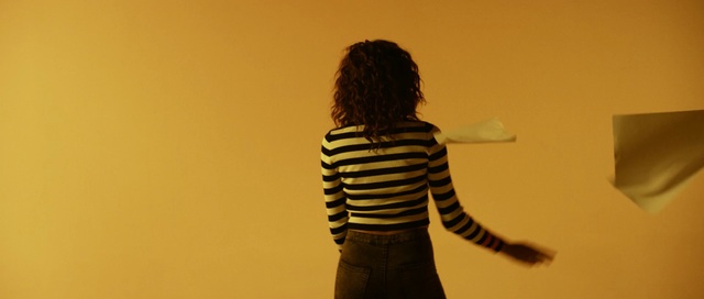 Video Reference: yellow, standing, light, shoulder, girl, outerwear, human, shadow, human behavior, fun, Person