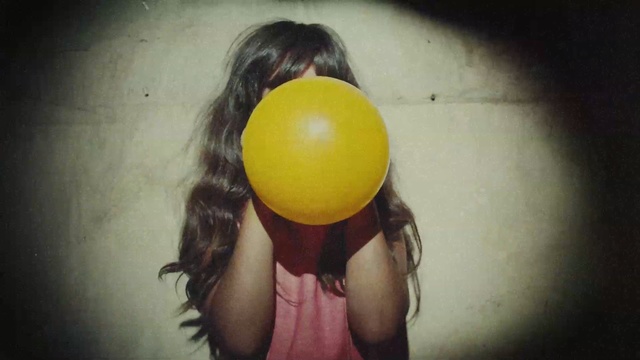 Video Reference: yellow, joint, girl, balloon, black hair, mouth, fun, hand, smile, neck