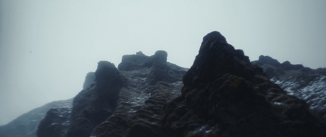 Video Reference: rock, mountainous landforms, mountain, sky, ridge, mountain range, formation, fog, landscape, mist