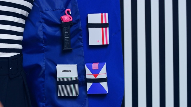 Video Reference: Blue, Cobalt blue, Clothing, Sportswear, Jersey, Electric blue, Uniform, Flag, Sleeve, Shirt, Striped, White, Table, Sitting, Black, Man, Holding, Large, Pair, Bed, Cutting, Display, Phone, Woman, Laying, Group, Standing, Text, Design