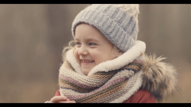 Video Reference: Knit cap, Child, Wool, Facial expression, Clothing, Beanie, Skin, Woolen, Cheek, Headgear, Person