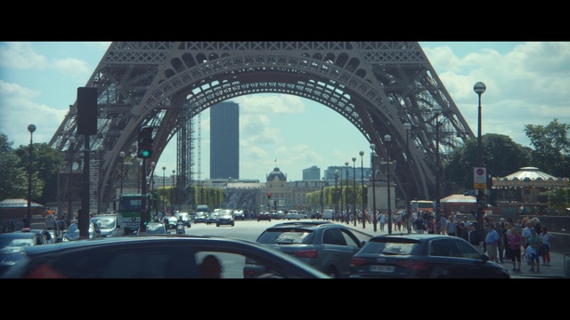 Video Reference: Metropolitan area, Landmark, Architecture, Arch, Urban area, Metropolis, City, Sky, Human settlement, Town, Outdoor, Building, Street, Road, Car, Bridge, Photo, View, Traffic, Driving, Red, Busy, Intersection, Sitting, Large, Bus, Light, Sign, Train, Traveling, Clock, Parked, Tower, Standing, People, Vehicle, Land vehicle, Skyscraper