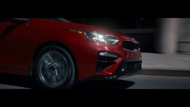 Video Reference: Land vehicle, Vehicle, Car, Automotive design, Automotive lighting, Mid-size car, Compact car, Automotive wheel system, Hatchback, Automotive exterior, Red, Road, Orange, Street, Small, Driving, City, White, Traveling, Riding, Mirror, Man, Fire, Night, Wheel, Automotive