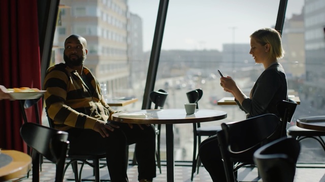 Video Reference: Conversation, Musician, Sitting, Music, Tourism, White-collar worker, Musical instrument, Performance, City, Restaurant, Person