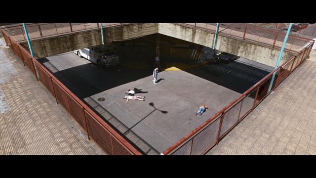 Video Reference: Games, Floor, Recreation, Indoor, Building, Room, Table, Railing, Ramp, Rail, Man, Sitting, Boat, Wooden, Large, Black, Platform, Riding, Young, Standing, Night, Holding, Playing, Bridge, Doing, Board, White, Air